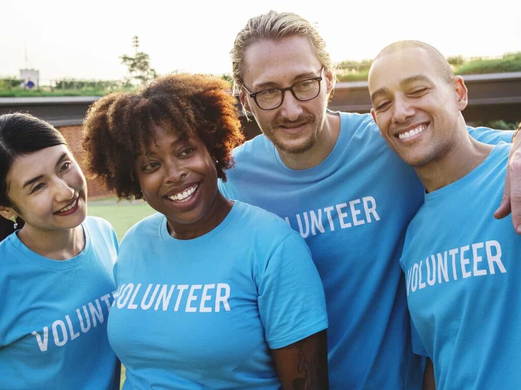 Photo of team of volunteers wearing blue shirts