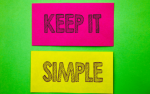 'Keep it simple' on bright post it notes against bright green background.