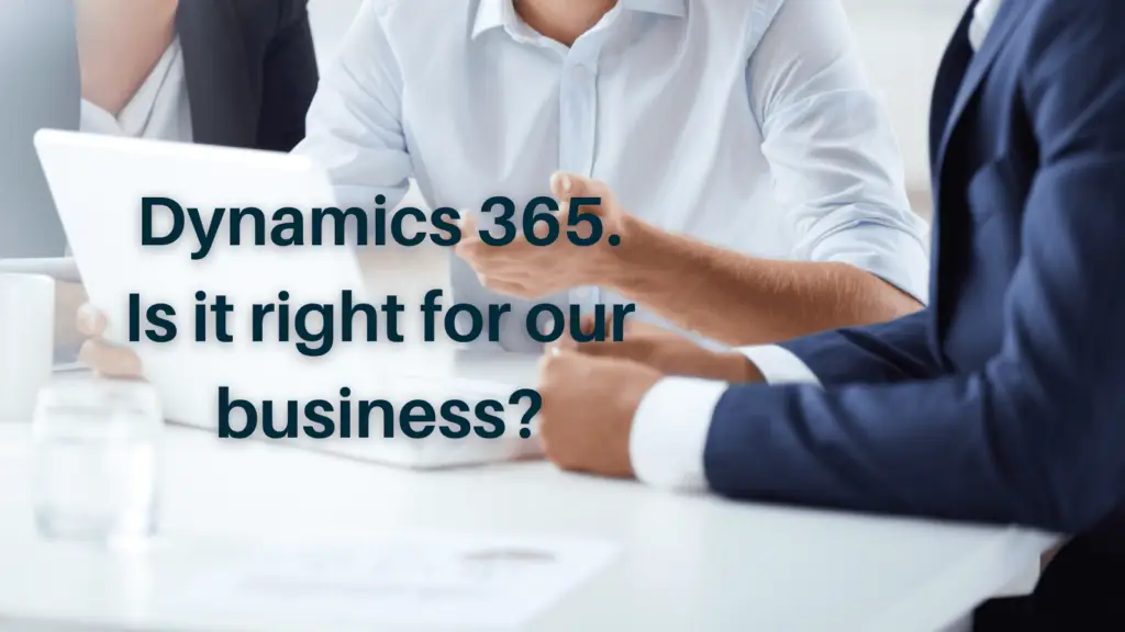 Employees in suits sat around desk with text 'Is Microsoft Dynamics 365 right for your business?