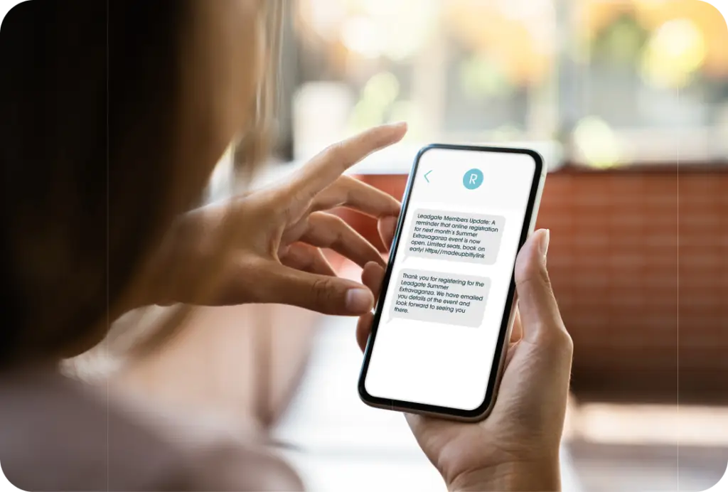 Close up of smart phone in hand showing membership organisation member text alerts.