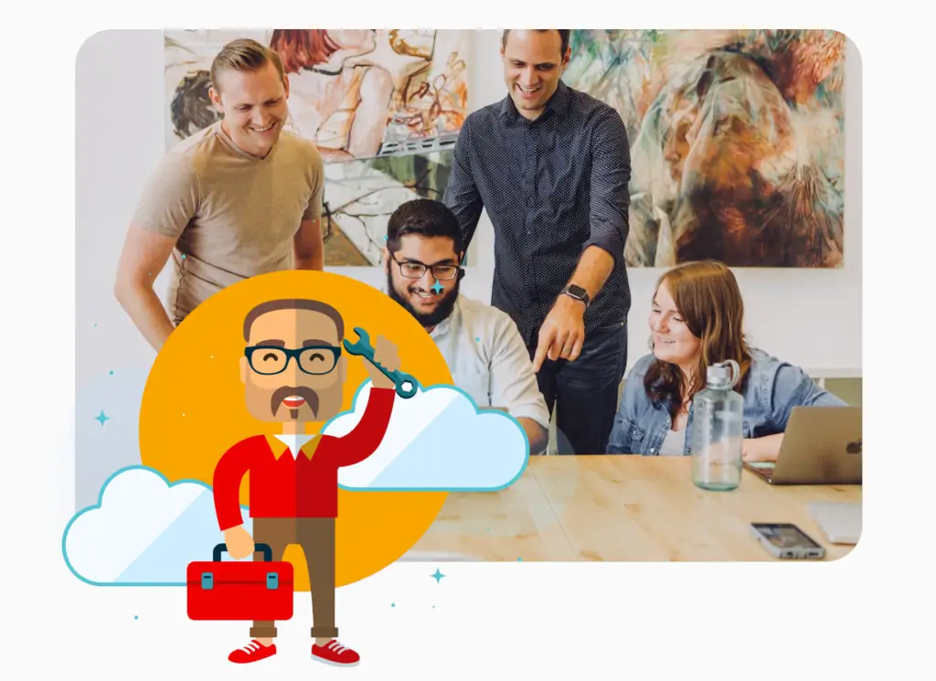 Colleagues standing around a co-worker who is sat working at a desk.